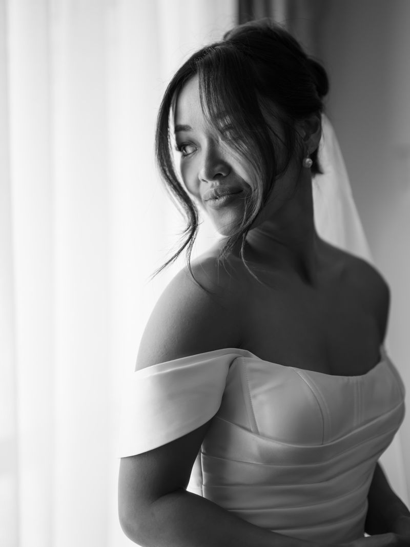 Bride in an off-shoulder gown with a soft updo