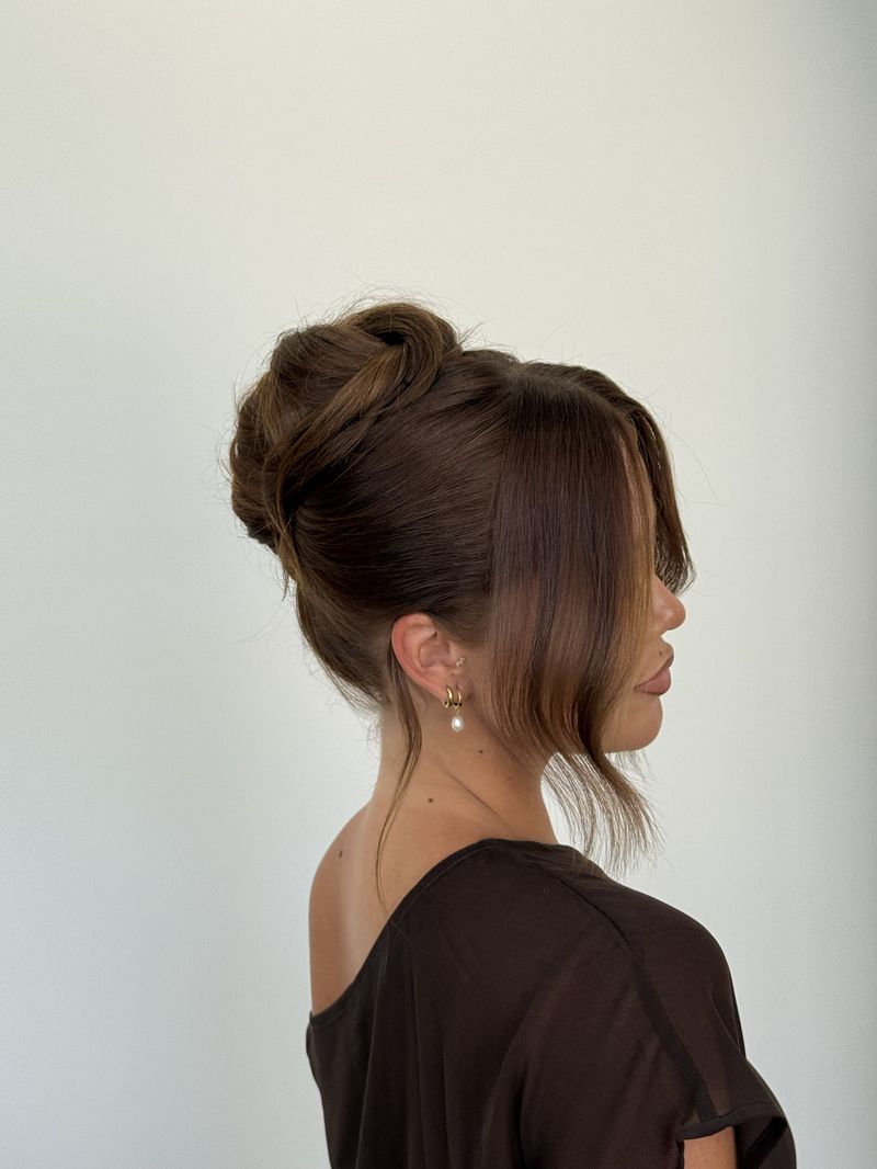 Polished twisted updo with curtain fringe